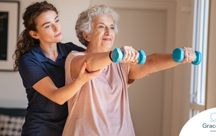 A physical therapist helps an older patient lift weights, representing how home health professionals can help with the hospital to home transition and the recovery that it entails.