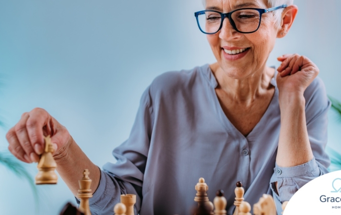 An older woman plays chess, an activity that can help older adults stay sharp.