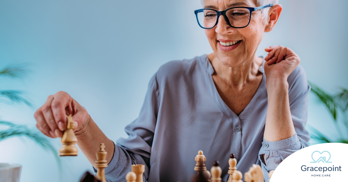 An older woman plays chess, an activity that can help older adults stay sharp.