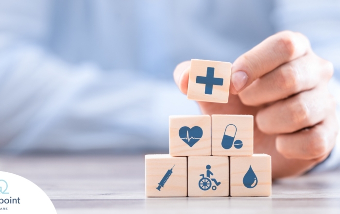 A stack of block with different health related icons represents health insurance which can help with home health care.