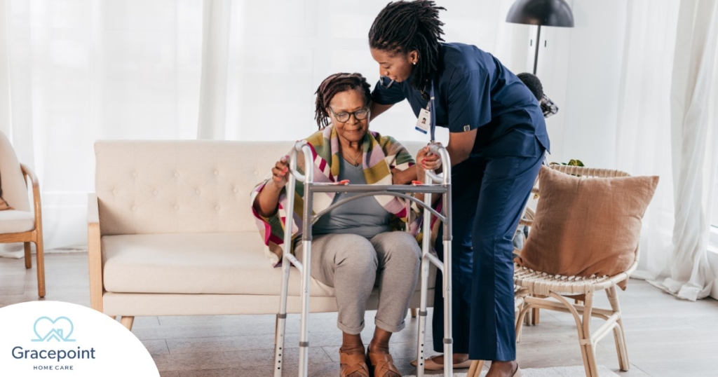 A care professional helps an older woman get up with the use of a walker, representing how occupational therapy can help with recovery.