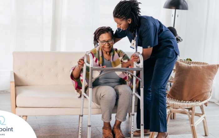 A care professional helps an older woman get up with the use of a walker, representing how occupational therapy can help with recovery.