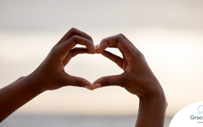 2 hands making a heart represent self-care, a vital concept to appreciate as a caregiver.