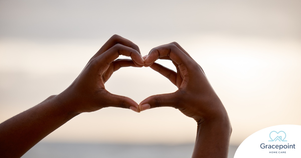 2 hands making a heart represent self-care, a vital concept to appreciate as a caregiver.