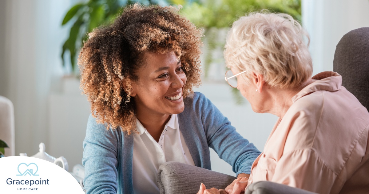 A caregiver warmly speaks with an older client, representing the quality communication that can come with bilingual care.