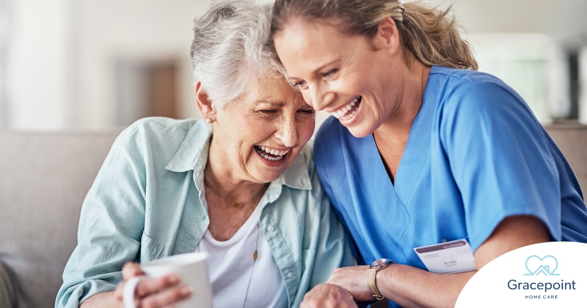 A caregiver laughs with a client representing how good social skills can help professional caregivers.