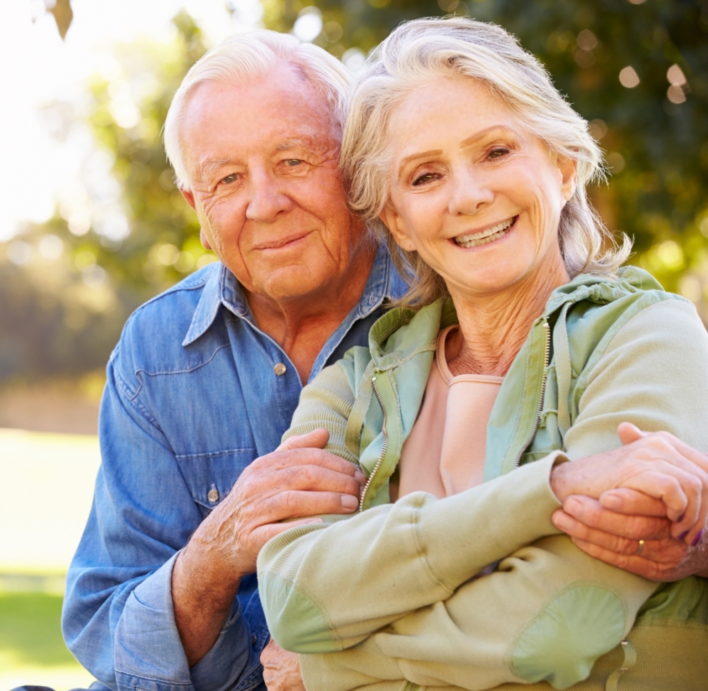 Companion Care in Gulf Shores (1) Senior couple holding hands and smiling, reflecting companion care in Gulf Shores, AL and the comfort of supportive relationships