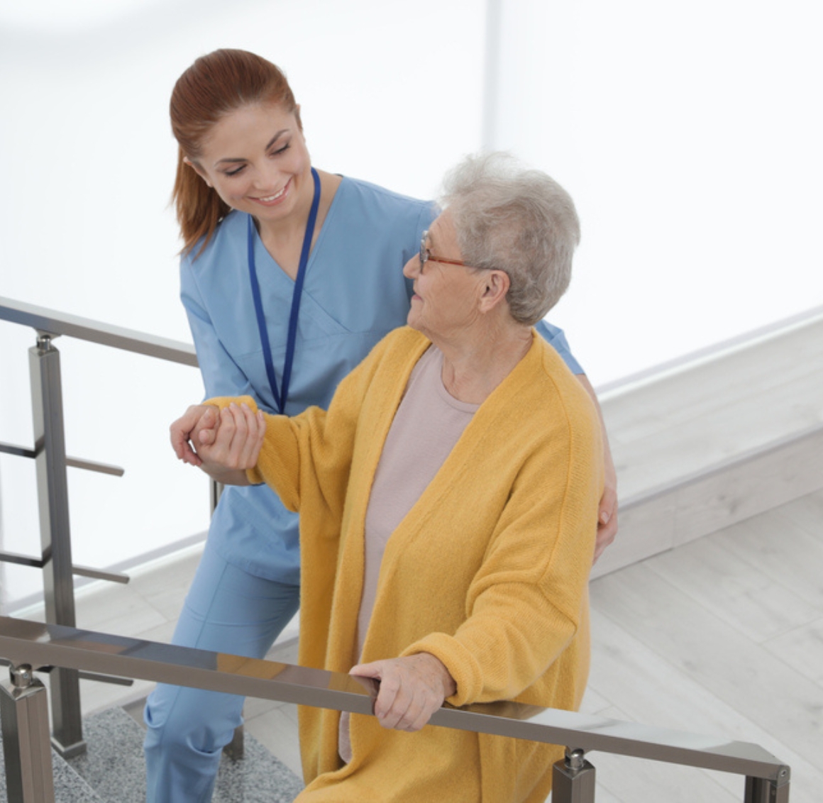 Caregiver assisting a senior on stairs, reflecting home health care in Gulf Shores, AL and safe, supportive daily mobility