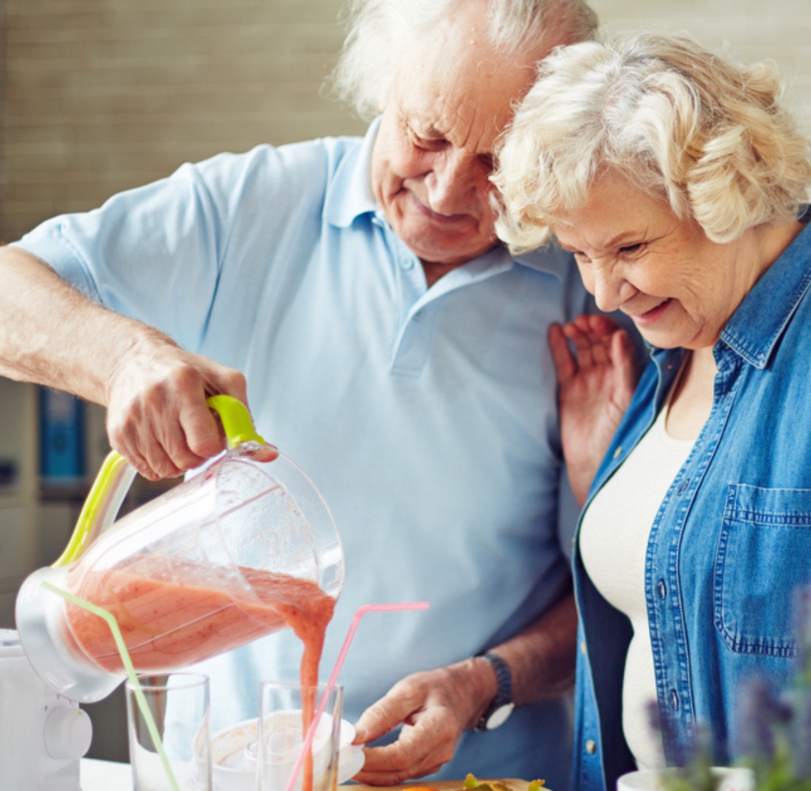 A senior couple enjoys meal preparation in Gulf Shores, working together in a bright, cozy kitchen. The woman chops fresh vegetables while the man stirs a pot on the stove, both smiling and engaged in the cooking process. A senior couple enjoys meal preparation in Gulf Shores, working together in a bright, cozy kitchen. The woman chops fresh vegetables while the man stirs a pot on the stove, both smiling and engaged in the cooking process.