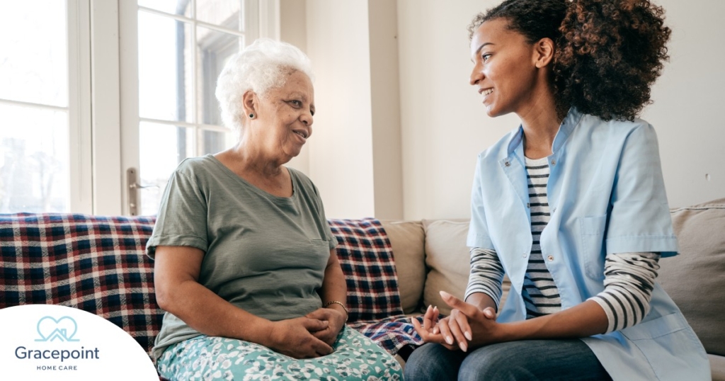 A caregiver sits and spends time with a client, representing how non-medical home care can benefit older loved ones.