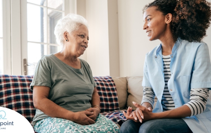 A caregiver sits and spends time with a client, representing how non-medical home care can benefit older loved ones.