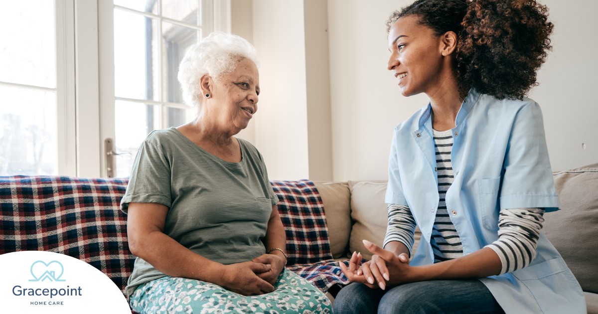 A caregiver sits and spends time with a client, representing how non-medical home care can benefit older loved ones.
