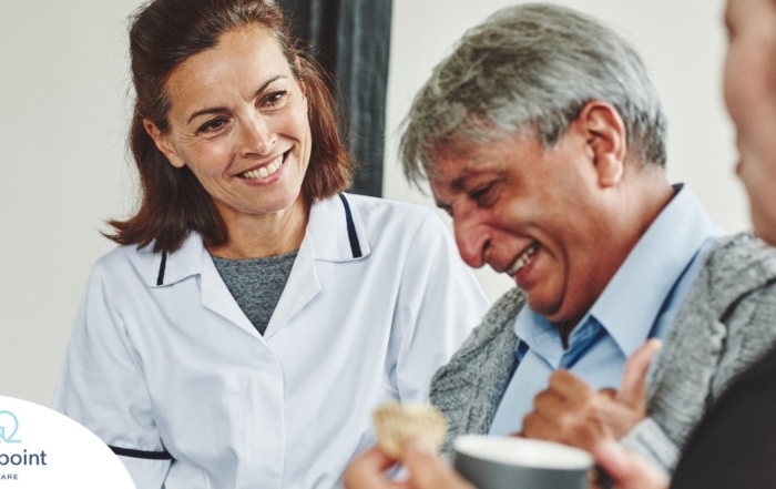 A woman smiles while with clients showing how you can enjoy senior caregiver jobs.