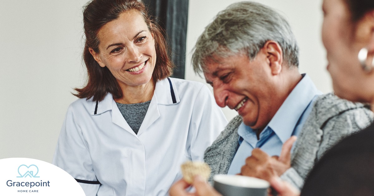 A woman smiles while with clients showing how you can enjoy senior caregiver jobs.