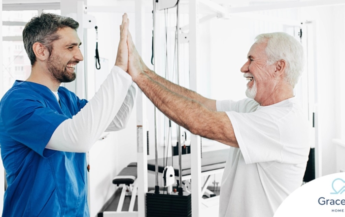 A healthcare worker and patient smile and high five representing the satisfaction that can come from a career as a physical therapy assistant.