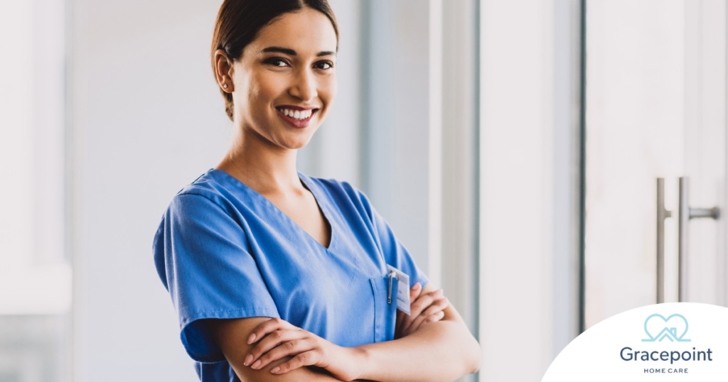A woman in scrubs smiles representing the satisfaction of finding out how to become a home health aide.