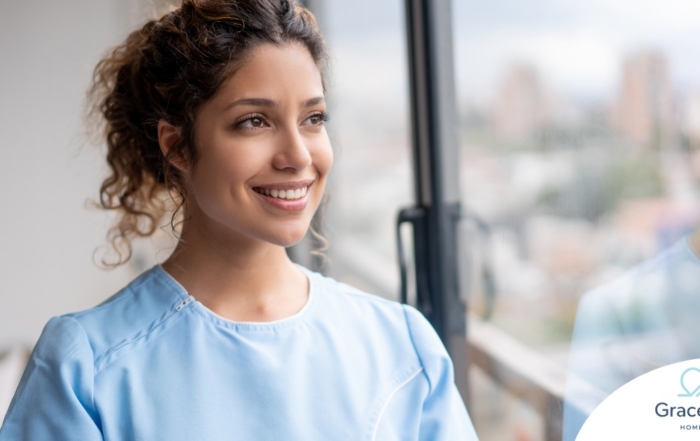 A woman smiles while looking ahead hopefully, showing the positive outlook that planning for a home care career can bring.