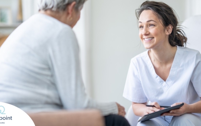 A woman smiles while with a client representing the pros of the home care industry.