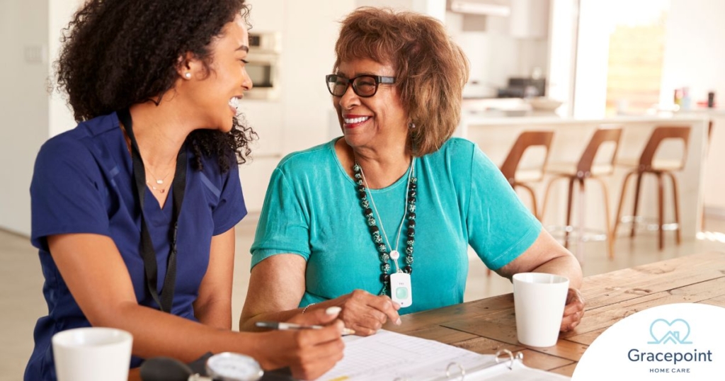 A care provider smiles with an older patient, representing the good results of speech therapy.
