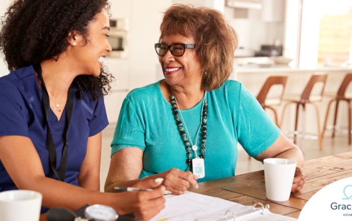A care provider smiles with an older patient, representing the good results of speech therapy.