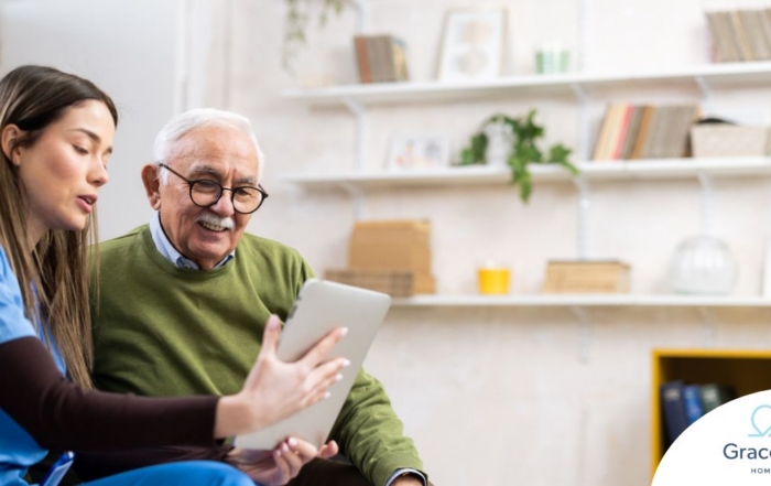 Home caregiver assisting senior man to use telehealth and senior care