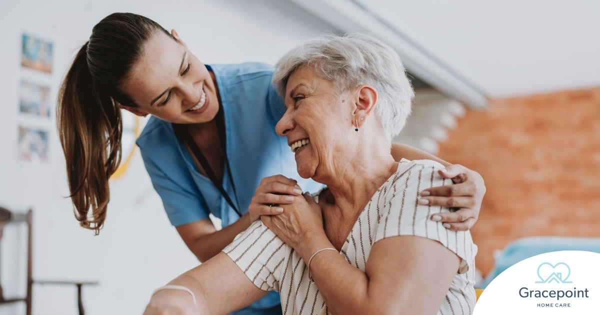 A female caregiver helping an older woman with stroke recovery at home.